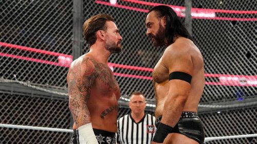 CM Punk, left, stares down Drew McIntyre inside the caged structure Hell in a Cell.