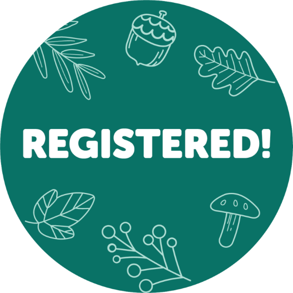 Registration badge pictured- green badge with assorted fall symbols, such as acorns, leaves and mushrooms