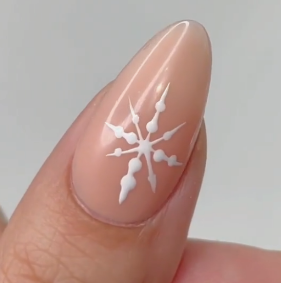 Manicure featuring white snowflake nail art.