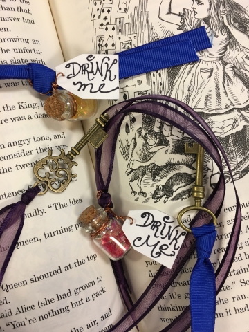 Alice-inspired bookmarks made from ribbon, mini bottles filled with glitter, and vintage keys