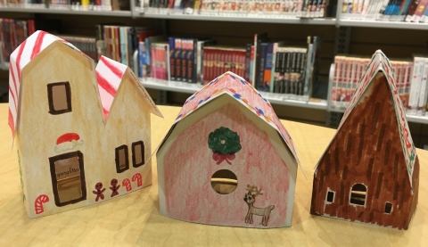 Three paper houses decorated with markers and colored pencils